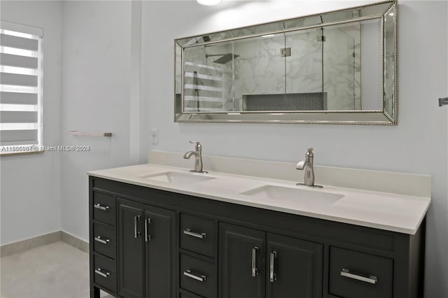 bathroom featuring a shower with door and vanity