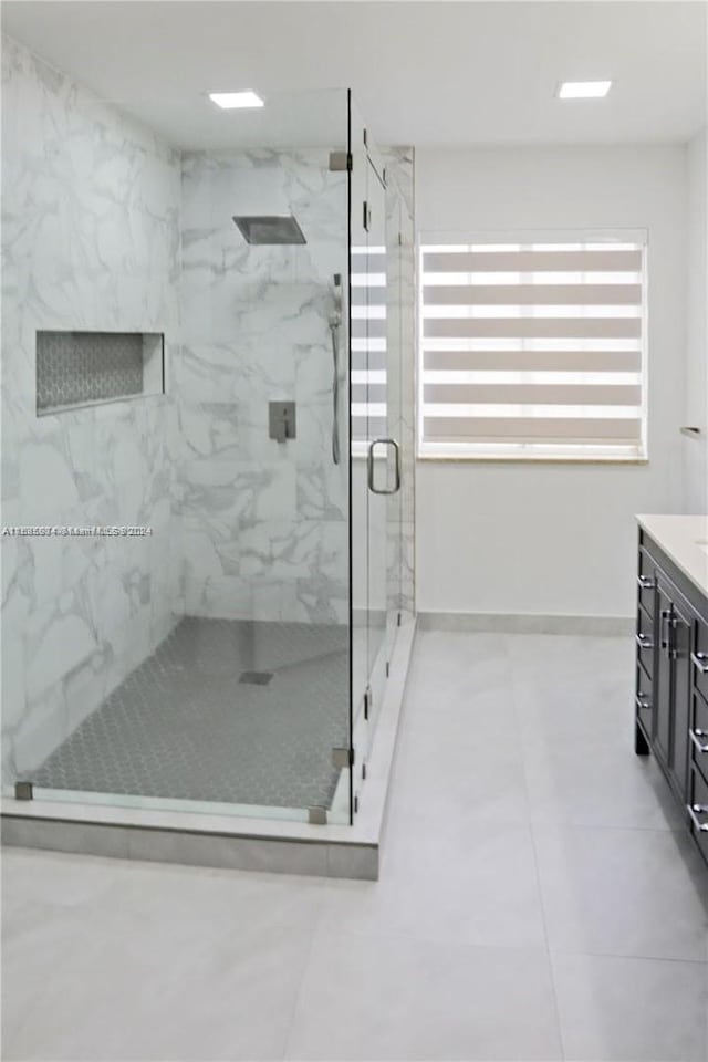 bathroom featuring an enclosed shower, vanity, and tile patterned floors