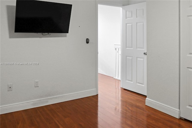 empty room with hardwood / wood-style flooring