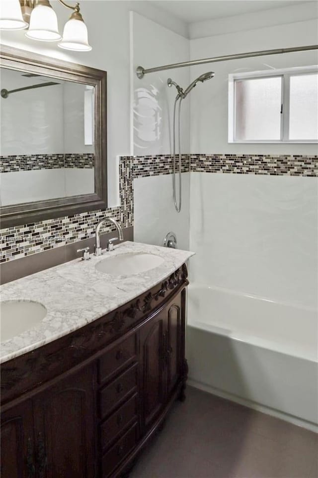 bathroom featuring tub / shower combination, vanity, and tasteful backsplash