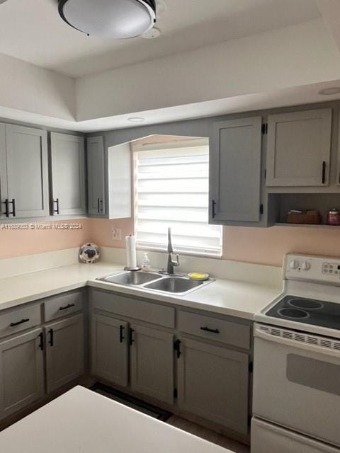 kitchen with gray cabinets, sink, and white electric range oven