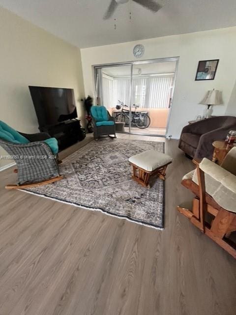 living room featuring hardwood / wood-style flooring and ceiling fan