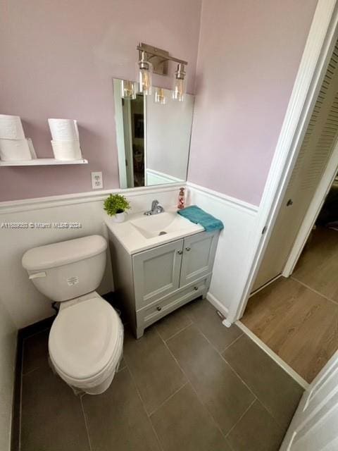 bathroom with vanity, tile patterned floors, and toilet