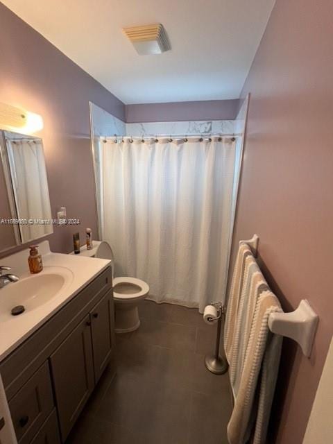 bathroom with tile patterned flooring, vanity, toilet, and a shower with curtain