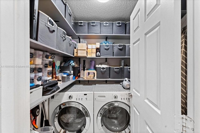 laundry room with a textured ceiling and independent washer and dryer