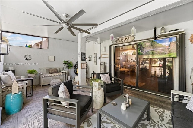 living room with dark wood-type flooring and ceiling fan