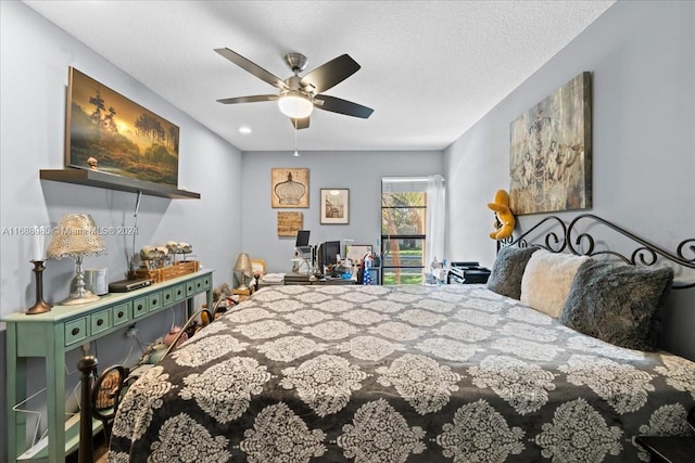 bedroom with a textured ceiling and ceiling fan