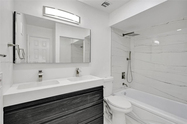 full bathroom with vanity, tiled shower / bath, and toilet