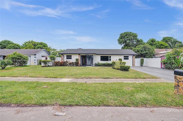 ranch-style home featuring a front yard