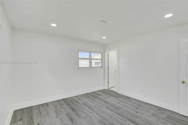 empty room with light hardwood / wood-style flooring