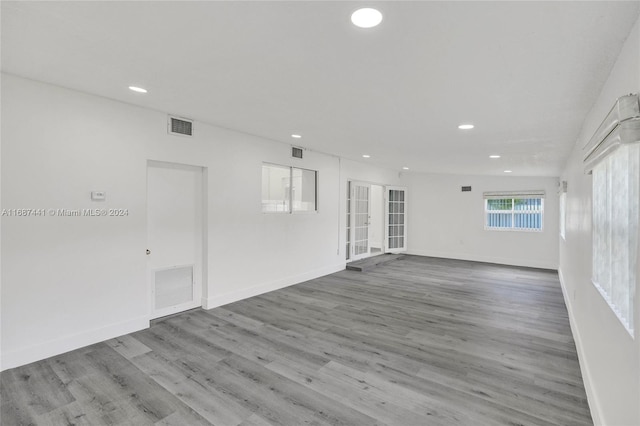 empty room featuring light hardwood / wood-style floors and french doors