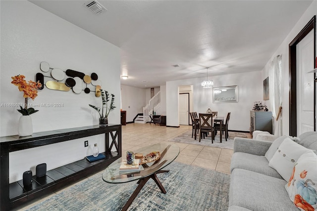 living room featuring a chandelier and light tile patterned floors