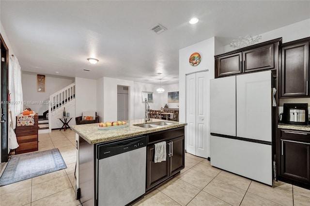 kitchen with light tile patterned flooring, a center island with sink, light stone counters, white fridge, and dishwasher