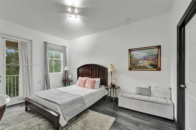 bedroom with dark hardwood / wood-style flooring and access to outside