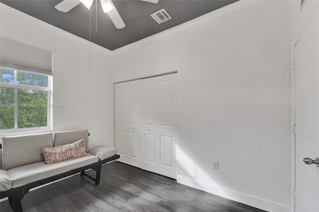 sitting room with dark hardwood / wood-style flooring and ceiling fan