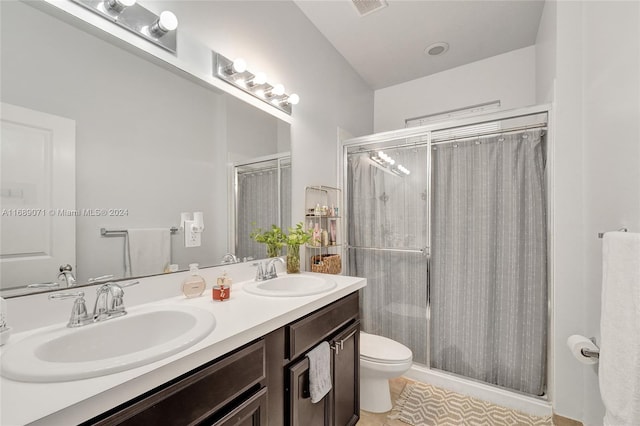 bathroom with toilet, a shower, vanity, and tile patterned flooring