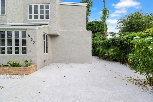 view of side of property featuring a patio area