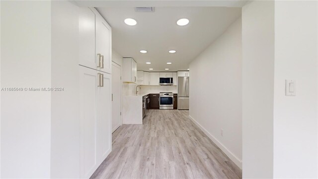 837 El Rado St, Coral Gables, FL 33134 - corridor with recessed lighting, light wood-style flooring, a sink, and baseboards