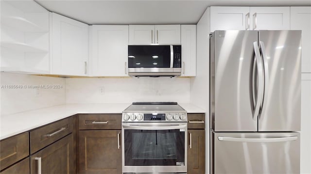 kitchen with white cabinets, dark brown cabinets, and stainless steel appliances