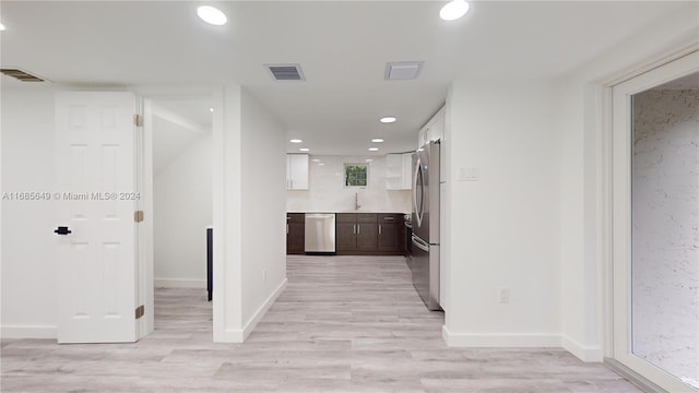 hall with sink and light hardwood / wood-style floors