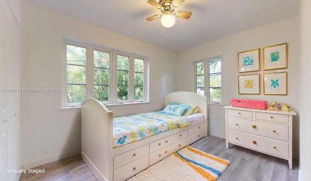 bedroom featuring light wood-type flooring and ceiling fan