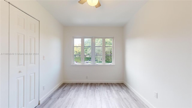 unfurnished bedroom with light hardwood / wood-style floors, ceiling fan, and a closet