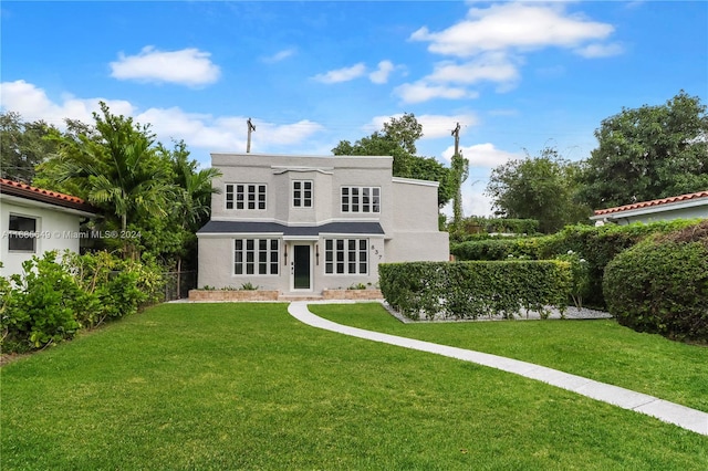 rear view of property with a yard