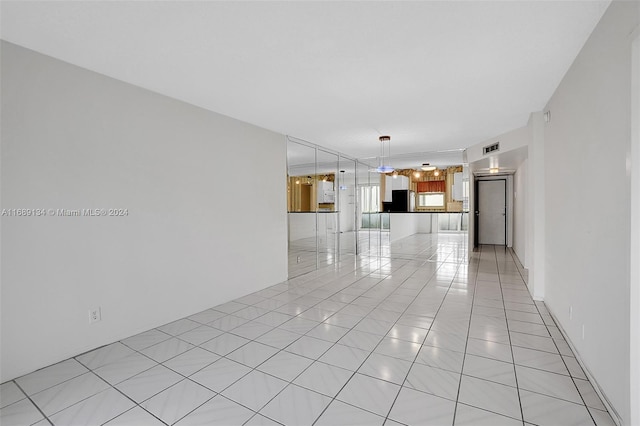 unfurnished living room with light tile patterned flooring