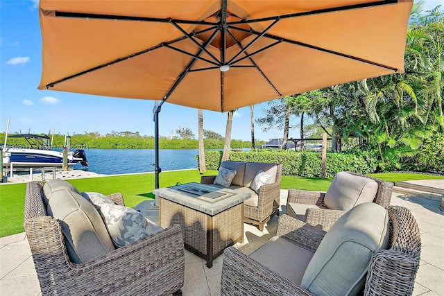 view of patio / terrace with an outdoor living space and a water view