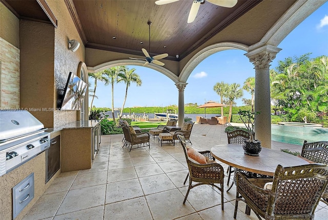 view of patio / terrace with an outdoor kitchen and ceiling fan