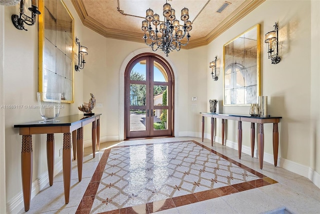 foyer entrance with french doors, a chandelier, and crown molding