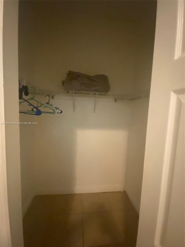 spacious closet featuring tile patterned flooring