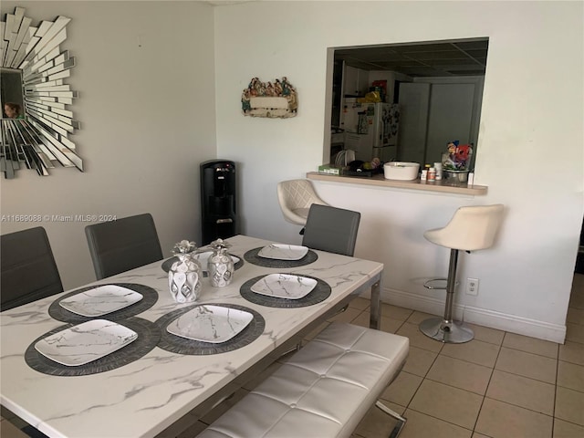 dining area with light tile patterned floors