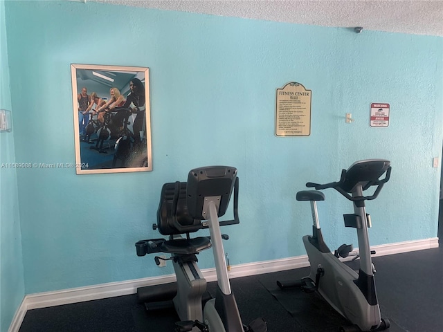 workout area with a textured ceiling