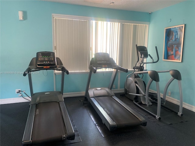 exercise room with a textured ceiling