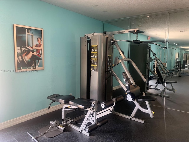 workout area featuring a textured ceiling