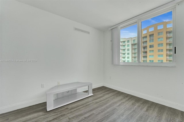 unfurnished room with wood-type flooring