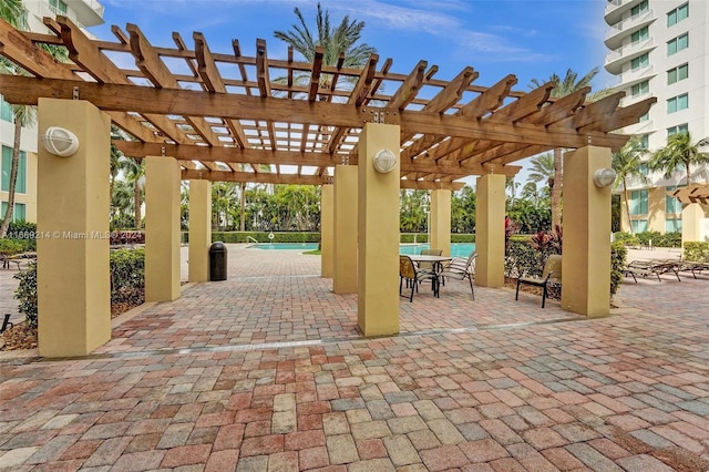 view of patio / terrace with a pergola and a water view