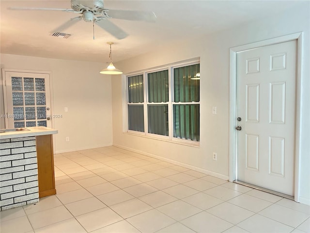 interior space with ceiling fan