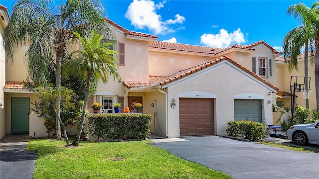 mediterranean / spanish-style home featuring a garage and a front yard