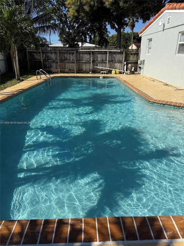 view of swimming pool with a patio