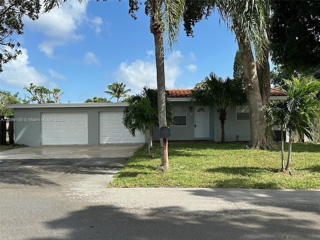 view of front of property with a front yard and a garage