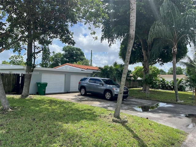 view of property exterior featuring a lawn and a garage