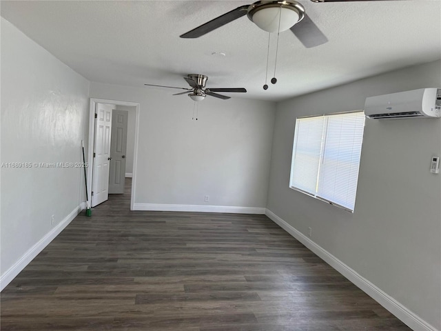 empty room with a wall mounted air conditioner, dark hardwood / wood-style floors, and ceiling fan