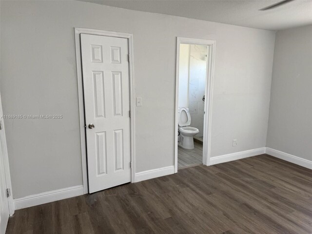 spare room featuring ceiling fan and dark hardwood / wood-style flooring