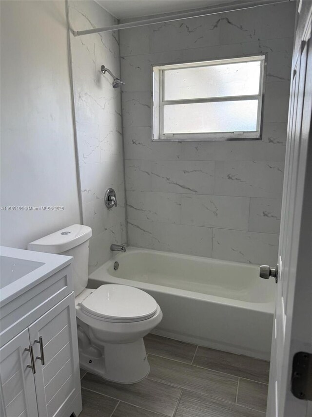 bathroom featuring vanity, toilet, and a tile shower