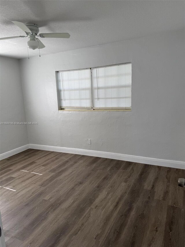 unfurnished room featuring a textured ceiling, ceiling fan, and dark wood-type flooring