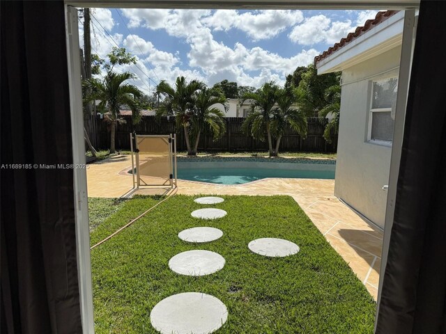 view of yard with a fenced in pool and a patio area