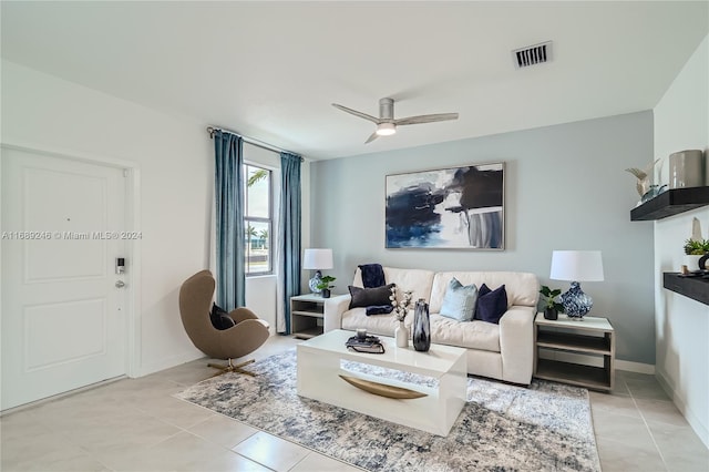 living room with ceiling fan and light tile patterned flooring