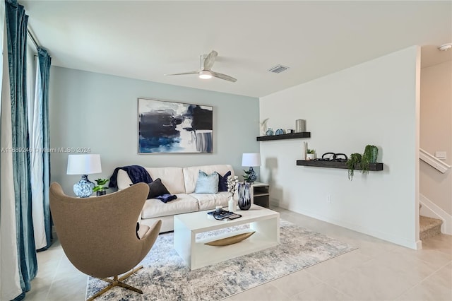 tiled living room with ceiling fan